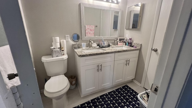 bathroom with tile patterned floors, vanity, and toilet