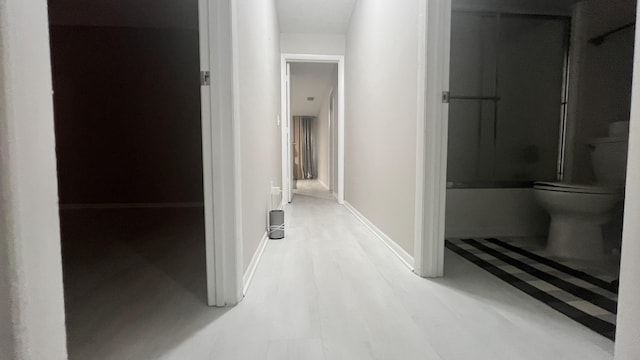 hallway with hardwood / wood-style flooring