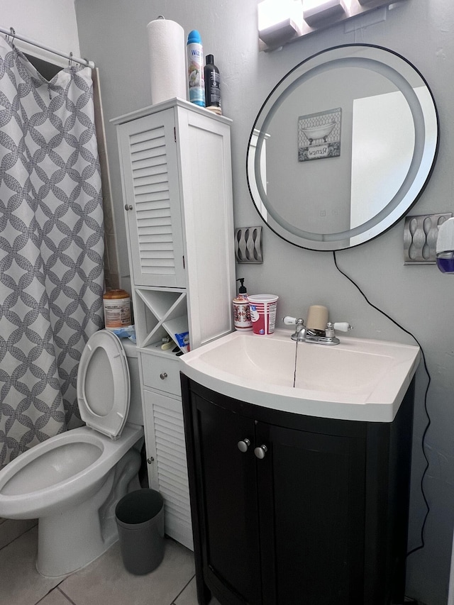 bathroom with tile patterned flooring, vanity, and toilet