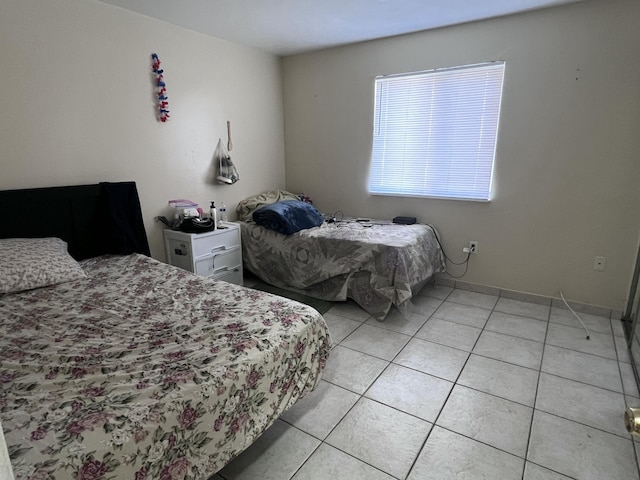 bedroom featuring light tile patterned floors