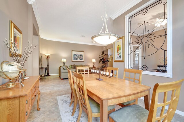 dining room with crown molding and light tile patterned floors