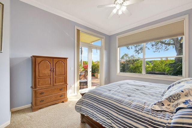 bedroom with crown molding, light colored carpet, french doors, and access to outside