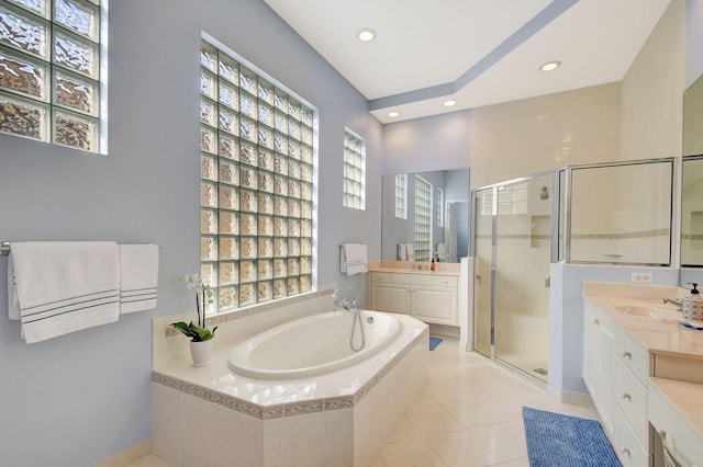 bathroom with plus walk in shower, vanity, and tile patterned floors