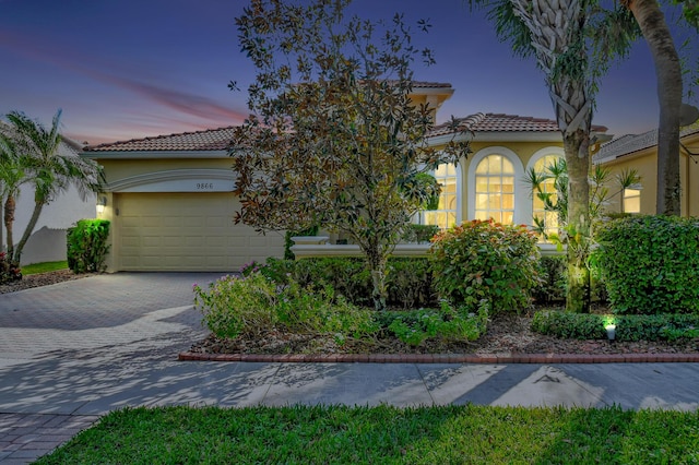 mediterranean / spanish-style home with a garage