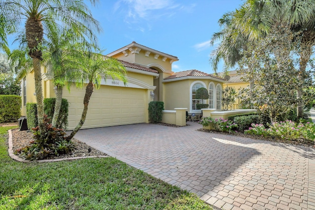 mediterranean / spanish-style home with a garage