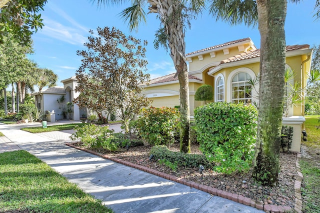 mediterranean / spanish-style house with a garage