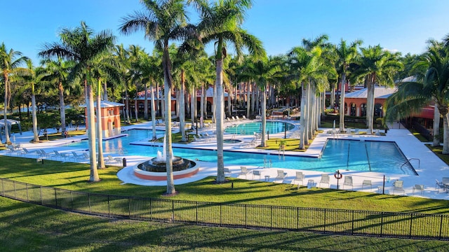 view of swimming pool with a lawn