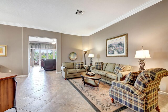 living room featuring ornamental molding and light tile patterned floors