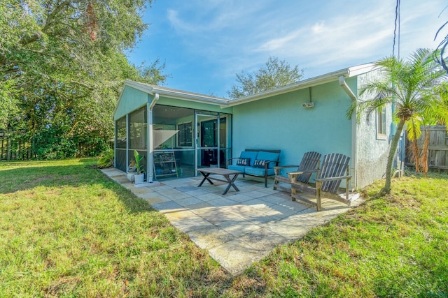 back of property featuring a yard, a patio, an outdoor hangout area, and a sunroom