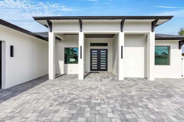 doorway to property with a patio area and french doors