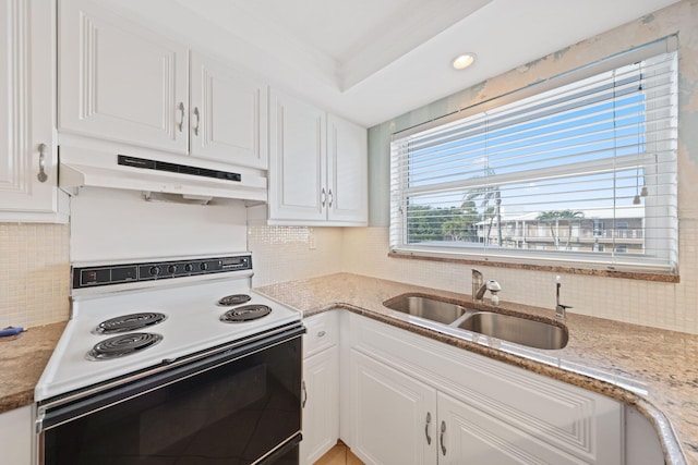 kitchen with white range with electric stovetop, white cabinetry, sink, and light stone countertops