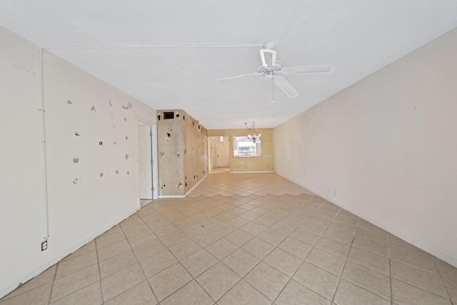 unfurnished room with ceiling fan with notable chandelier and light tile patterned flooring