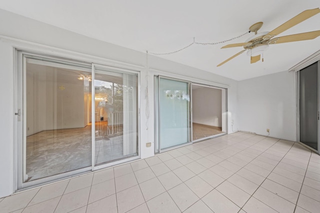 unfurnished sunroom with ceiling fan