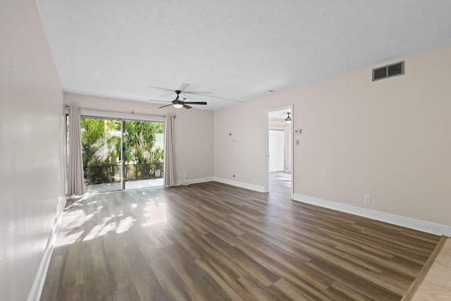 spare room featuring ceiling fan, dark hardwood / wood-style flooring, and a textured ceiling