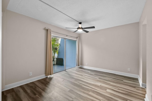 spare room featuring a textured ceiling, light hardwood / wood-style floors, and ceiling fan