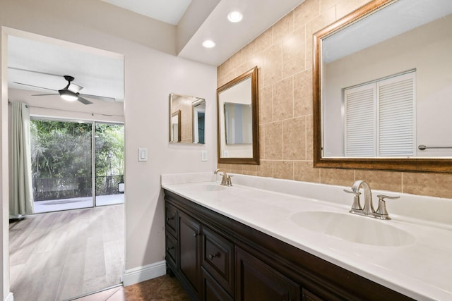 bathroom with ceiling fan, tile walls, and vanity