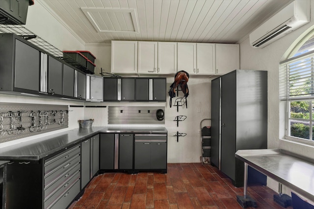 kitchen featuring gray cabinets, a wall mounted AC, crown molding, and white cabinets