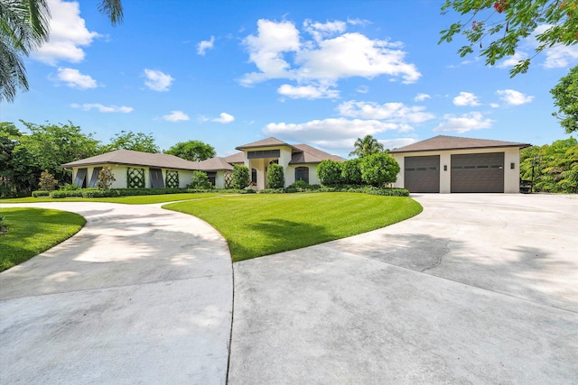 view of front facade with a garage and a front lawn