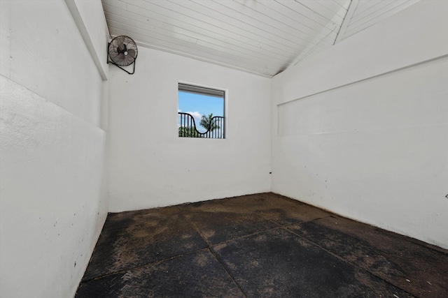 empty room featuring wood ceiling and vaulted ceiling