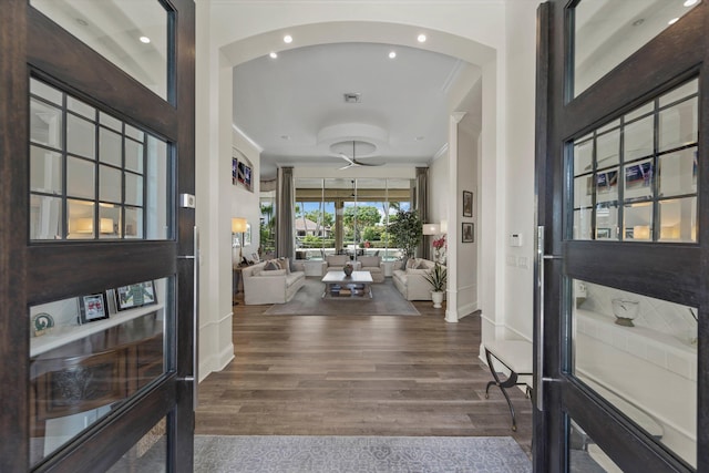 foyer featuring ornamental molding and dark wood-type flooring