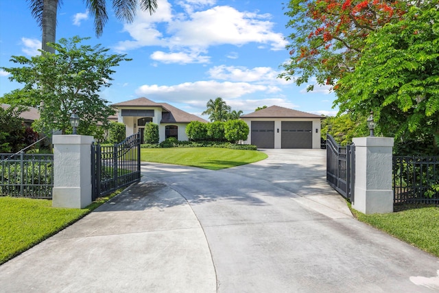 view of front of house featuring a front yard, an outbuilding, and a garage