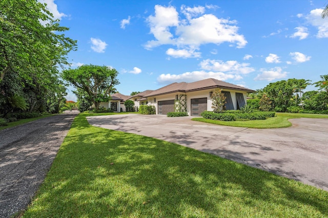 view of front of home featuring a garage and a front yard