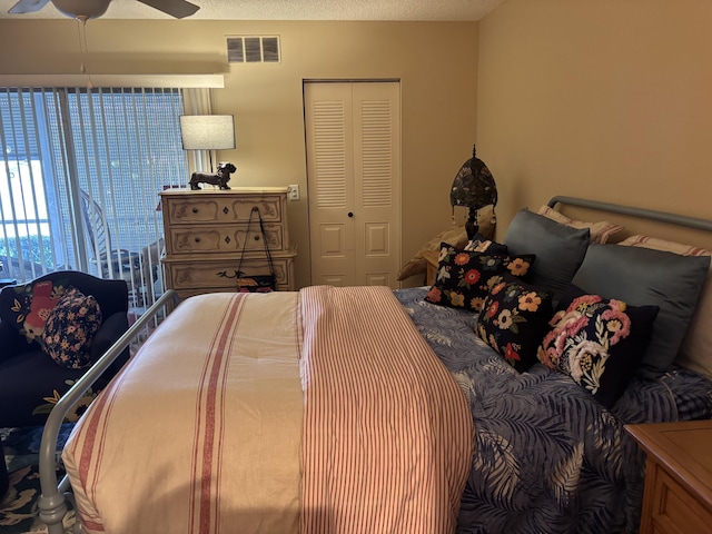 bedroom featuring a textured ceiling, a closet, and ceiling fan