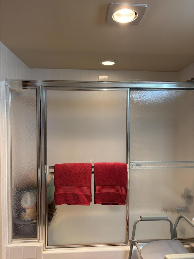 bathroom featuring a shower with shower door