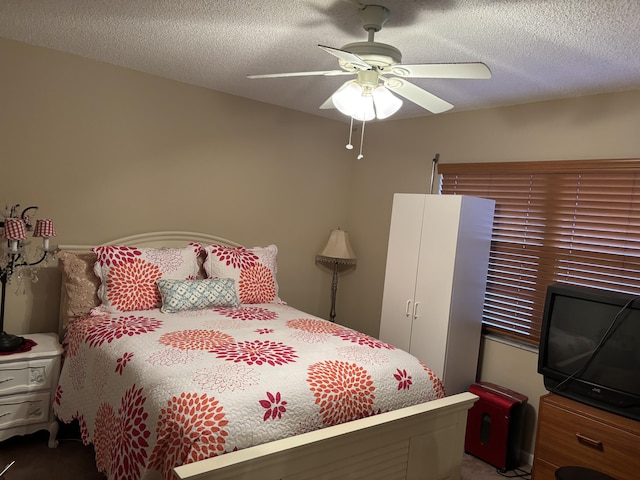 bedroom with a textured ceiling and ceiling fan