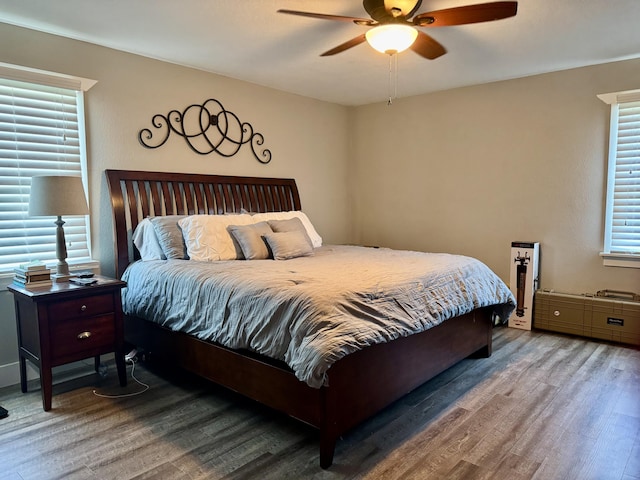 bedroom featuring a ceiling fan and wood finished floors