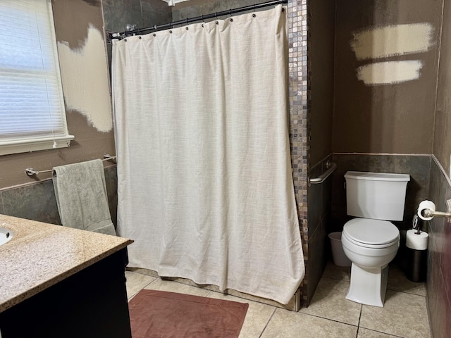 bathroom featuring a shower with shower curtain, vanity, toilet, and tile patterned floors