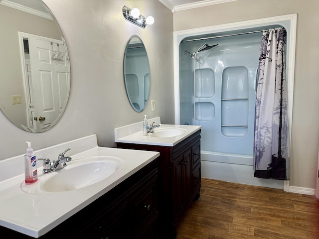 bathroom with ornamental molding, a sink, shower / bathtub combination with curtain, and wood finished floors