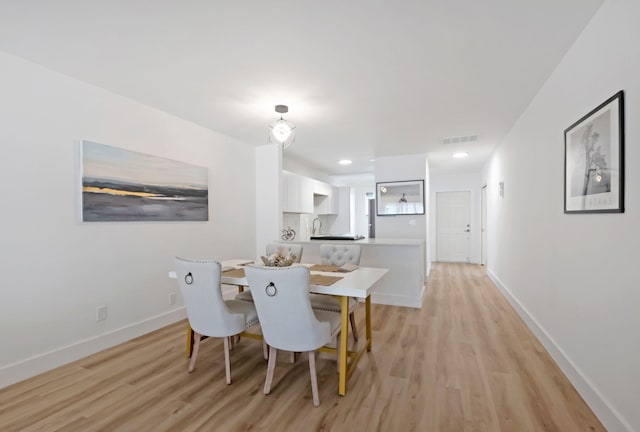 dining area with light wood-type flooring