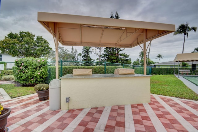 view of patio / terrace featuring exterior bar and exterior kitchen