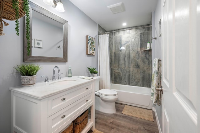 full bathroom featuring hardwood / wood-style floors, vanity, toilet, and shower / bathtub combination with curtain