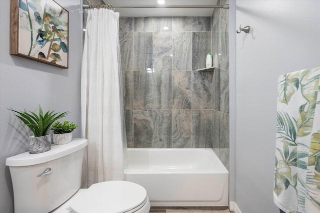 bathroom featuring shower / bath combo and toilet