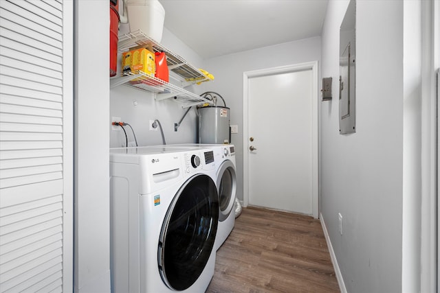 clothes washing area featuring independent washer and dryer, dark hardwood / wood-style flooring, and electric water heater