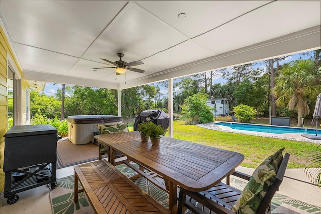 view of patio / terrace featuring a swimming pool with hot tub, ceiling fan, an outdoor structure, and a grill