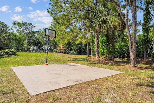 view of sport court featuring a lawn and a playground