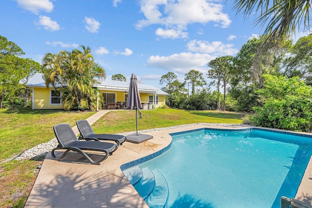 view of swimming pool with a lawn and a patio area