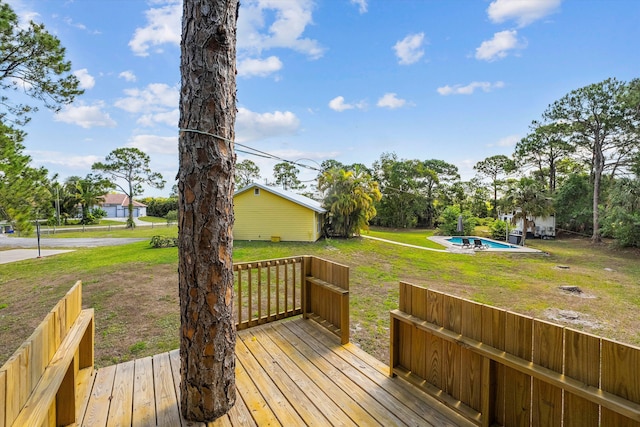 wooden terrace with a fenced in pool and a yard