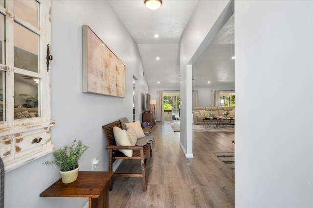 corridor featuring a textured ceiling and hardwood / wood-style flooring