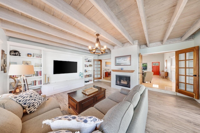 living area with wood finished floors, a chandelier, wood ceiling, beamed ceiling, and a fireplace