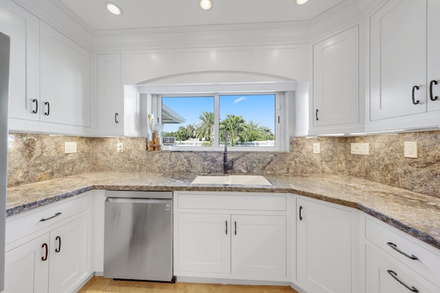 kitchen featuring white cabinetry, light stone countertops, sink, and stainless steel dishwasher