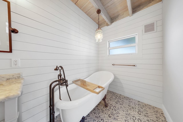 bathroom featuring beamed ceiling, wood walls, wood ceiling, and a washtub