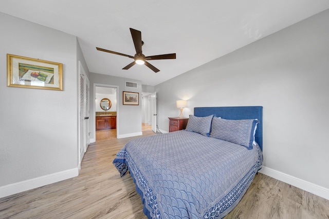 bedroom featuring connected bathroom, ceiling fan, and light hardwood / wood-style flooring