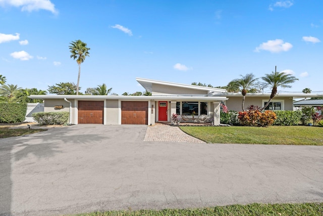 ranch-style house featuring a garage and a front yard