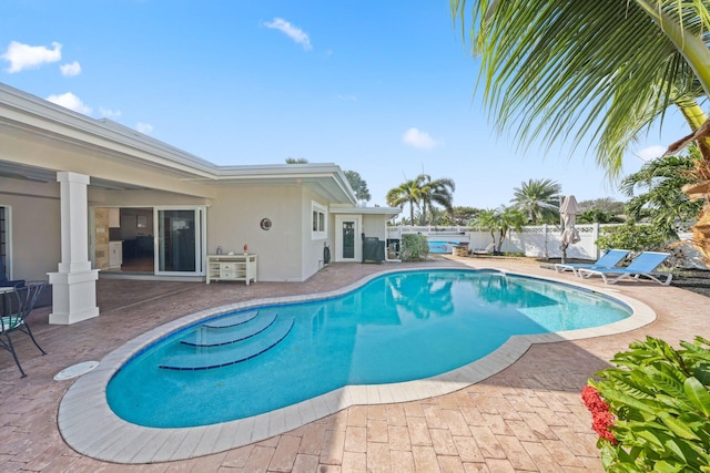 view of swimming pool with a fenced in pool, a patio, and fence