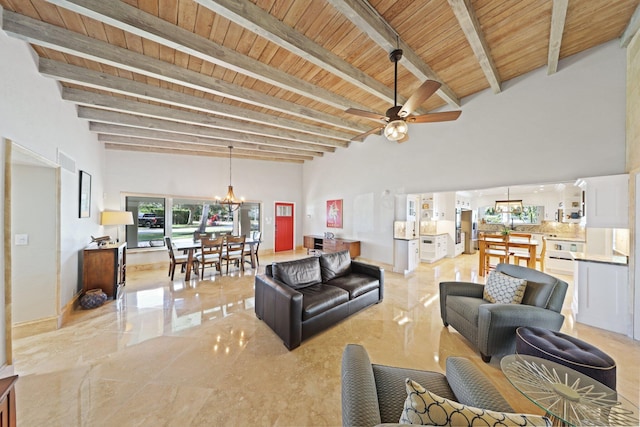 living room with wood ceiling, beamed ceiling, ceiling fan with notable chandelier, and a high ceiling