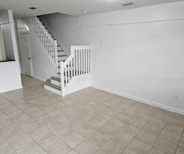 stairs with tile patterned floors